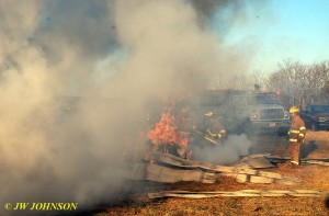 Hay Bale on Fire by Barn