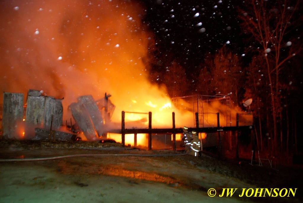 Firefighters At Back Deck of House