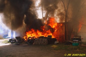 36 Tires on Fire Behind Shed